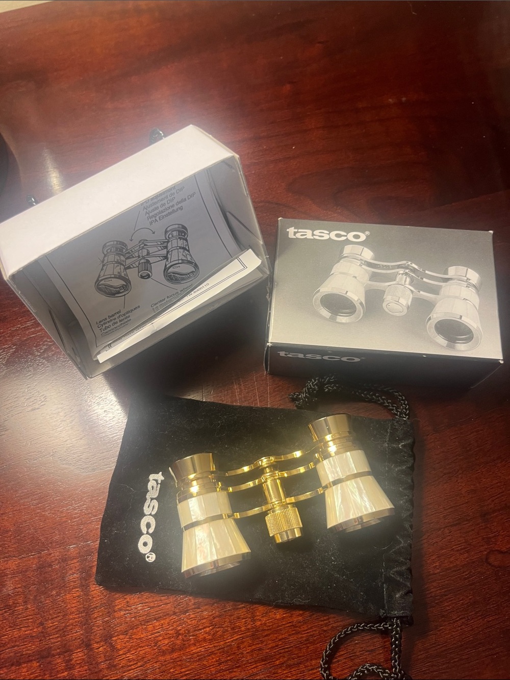 Tasco gold-tone opera glasses with the original box, velvet bag, and instruction